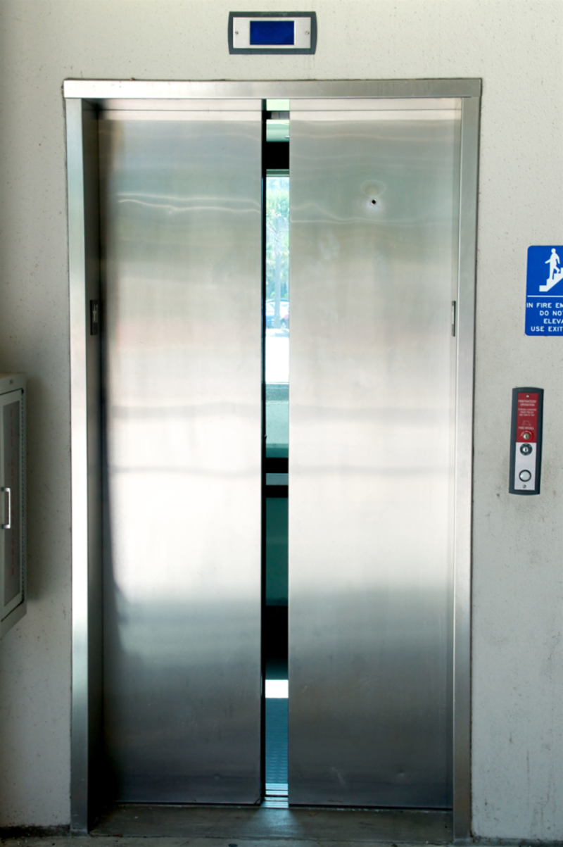 Hole on Elevator Doors | Alamy Stock Photo