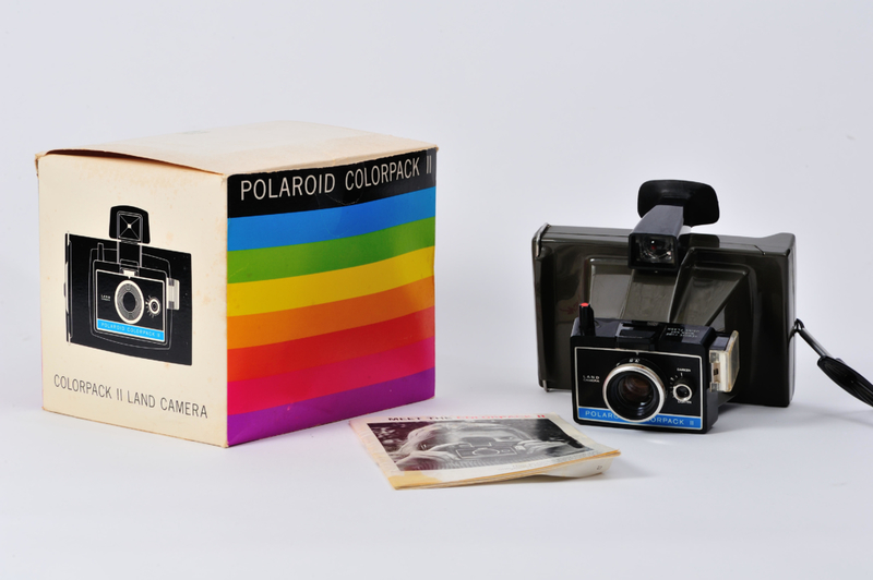 Starkes Schütteln von Polaroid-Fotos, damit sie sich schneller entwickeln | Alamy Stock Photo by Bradley Sauter 