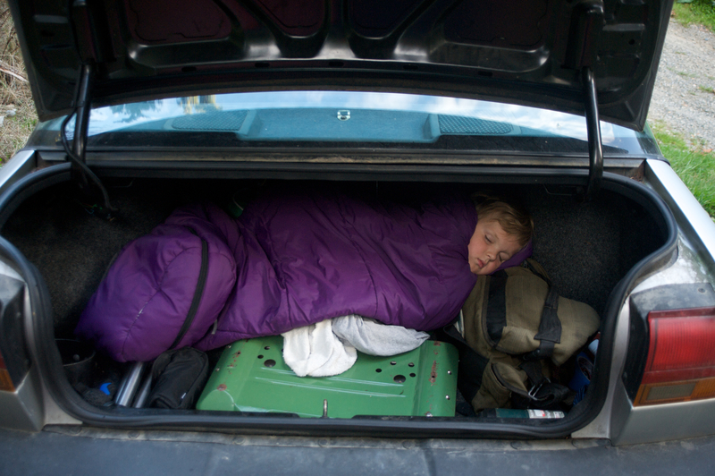 Sleeping in a Bag in a Car | Getty Images Photo by Aaron McCoy